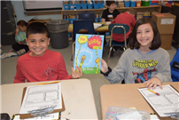 Two students holding a Dr. Suess book thumbnail242996